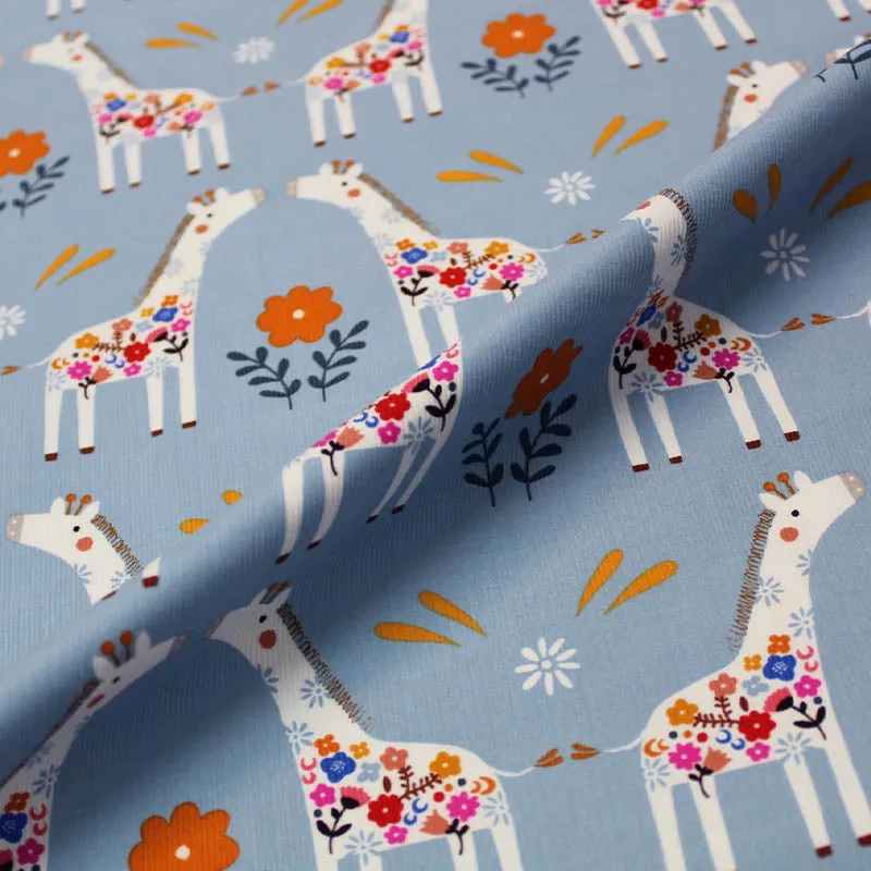 Dressmaking Fabric - Pale Blue Corduroy with Kissing Giraffes